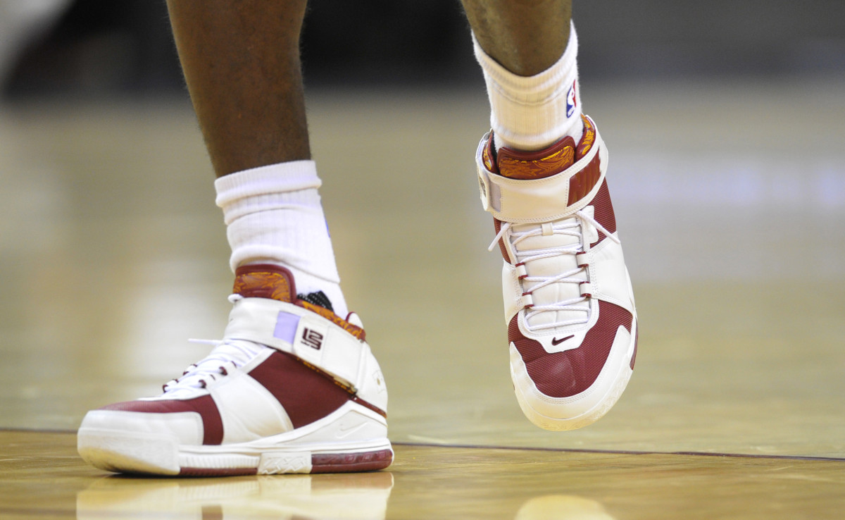 View of white and red Nike LeBron shoes.